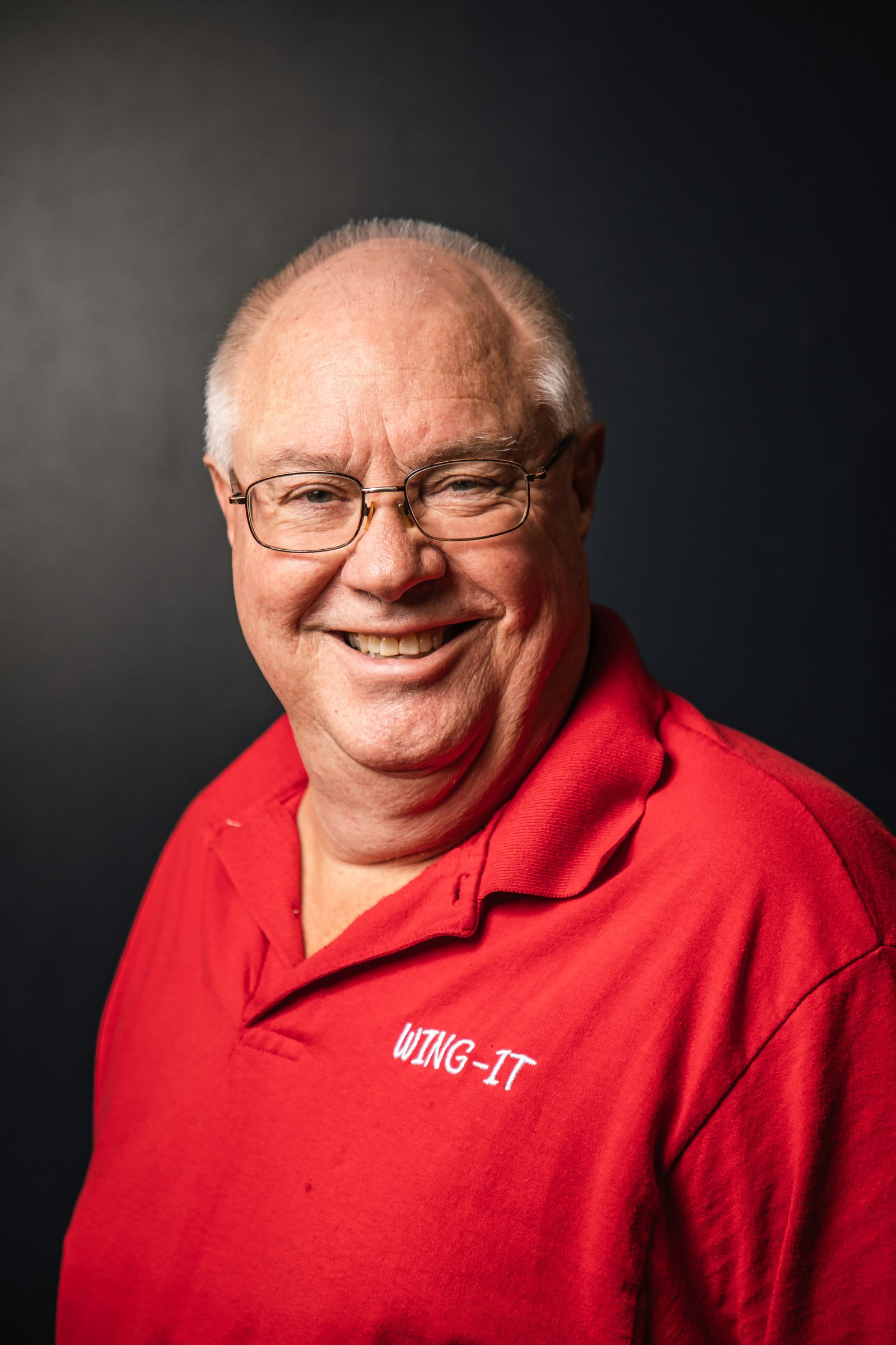 Dave, the owner of Wing It, in a red Wing It polo shirt
