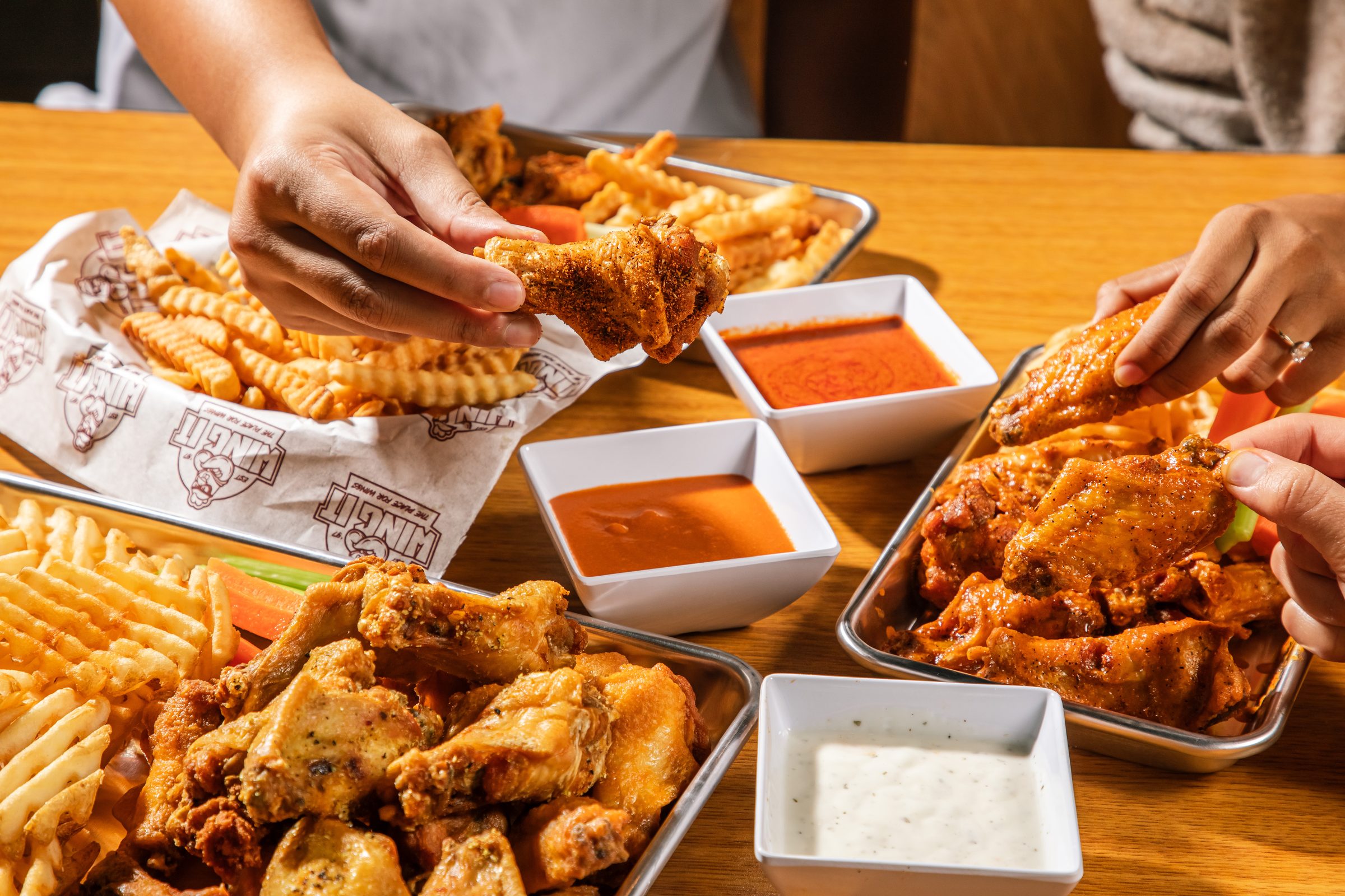 Wing It wings served with four dipping sauces